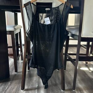 NWT sexy Free People bodysuit with snap closure in a sheer material.